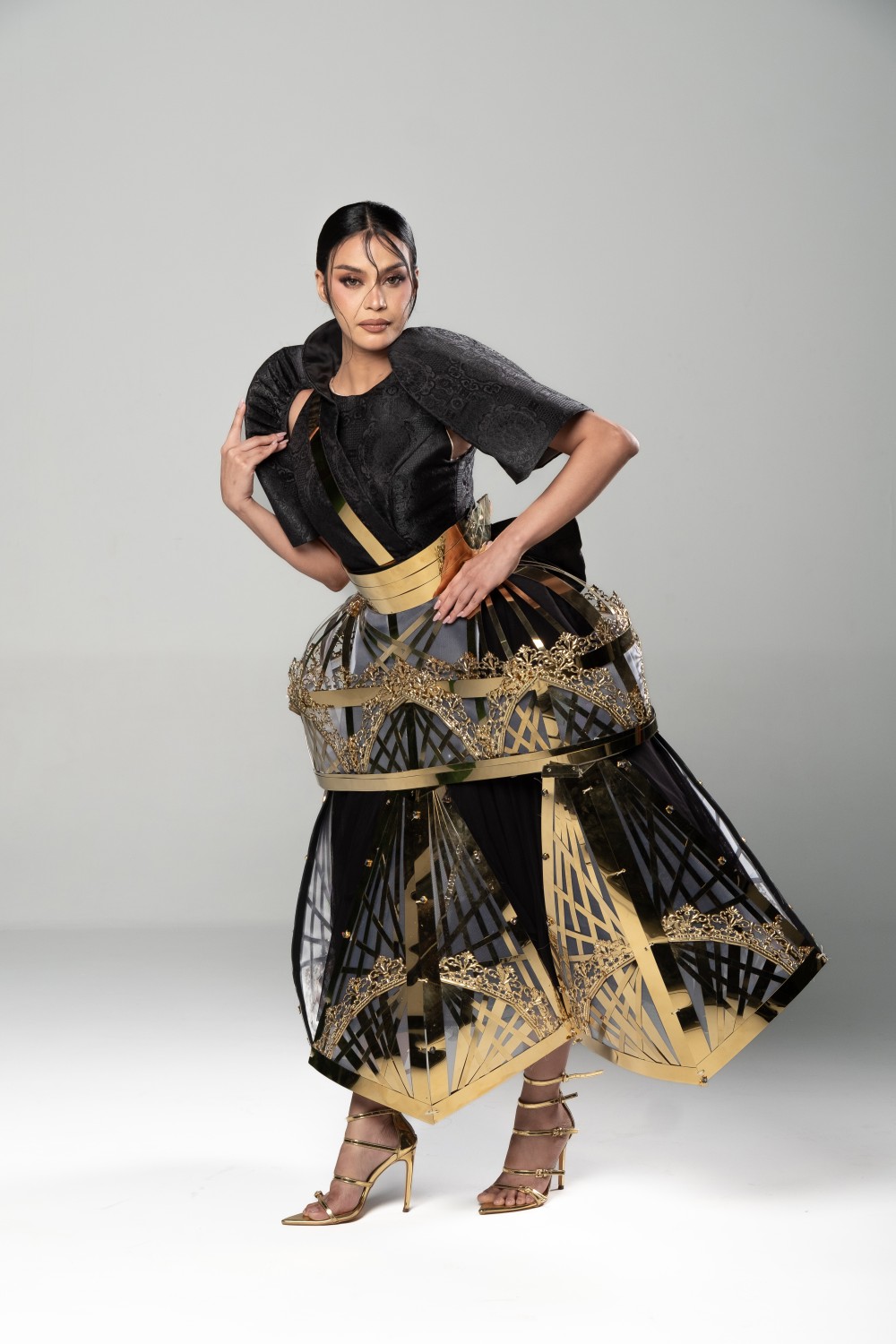modern Filipiniana dress with geometric metal skirt frame and structured butterfly sleeves