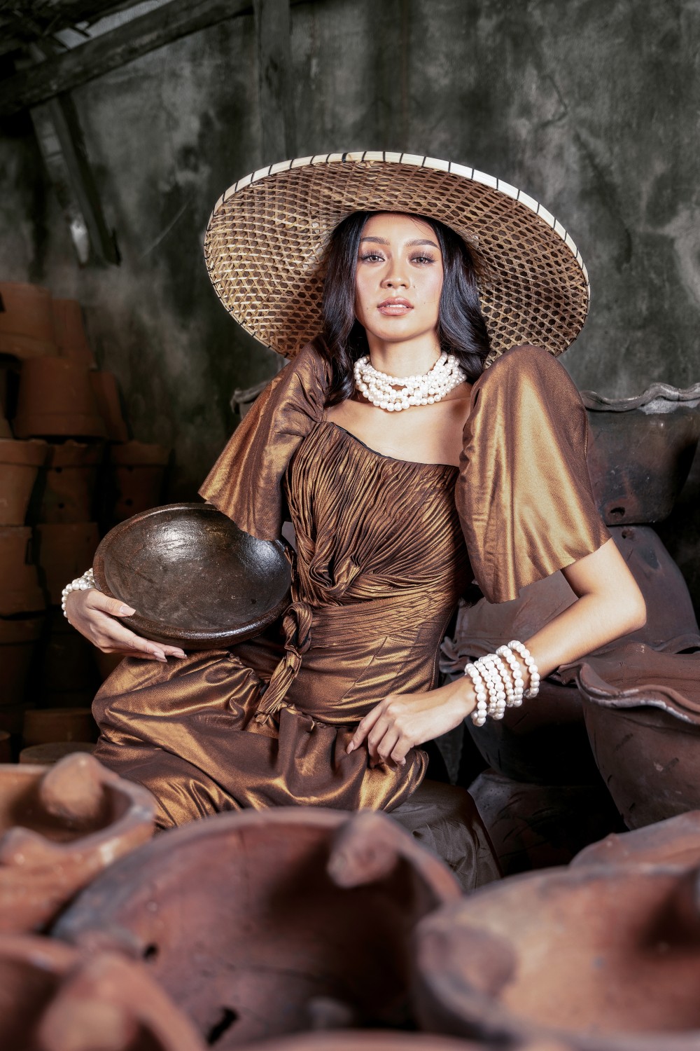 Sunset Over Palawan Filipiniana dress with bronze draped bodice, butterfly sleeves, woven hat, and pearl details