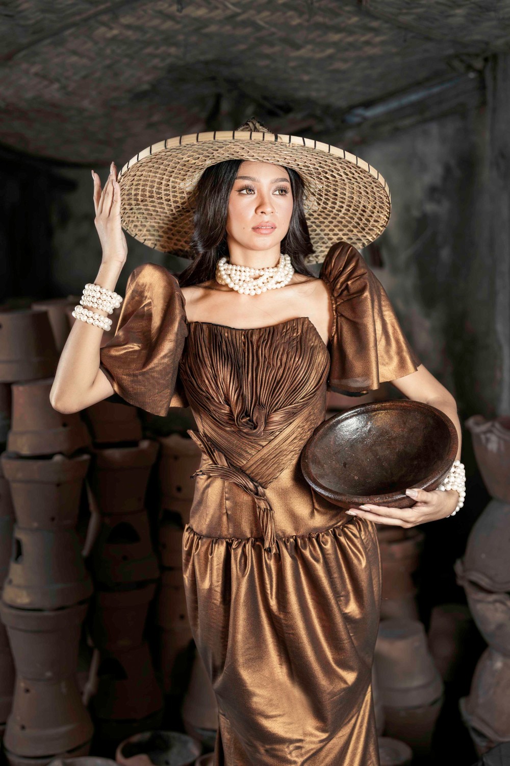 Sunset Over Palawan Filipiniana dress with bronze fabric, butterfly sleeves, woven hat, and pearl accessories