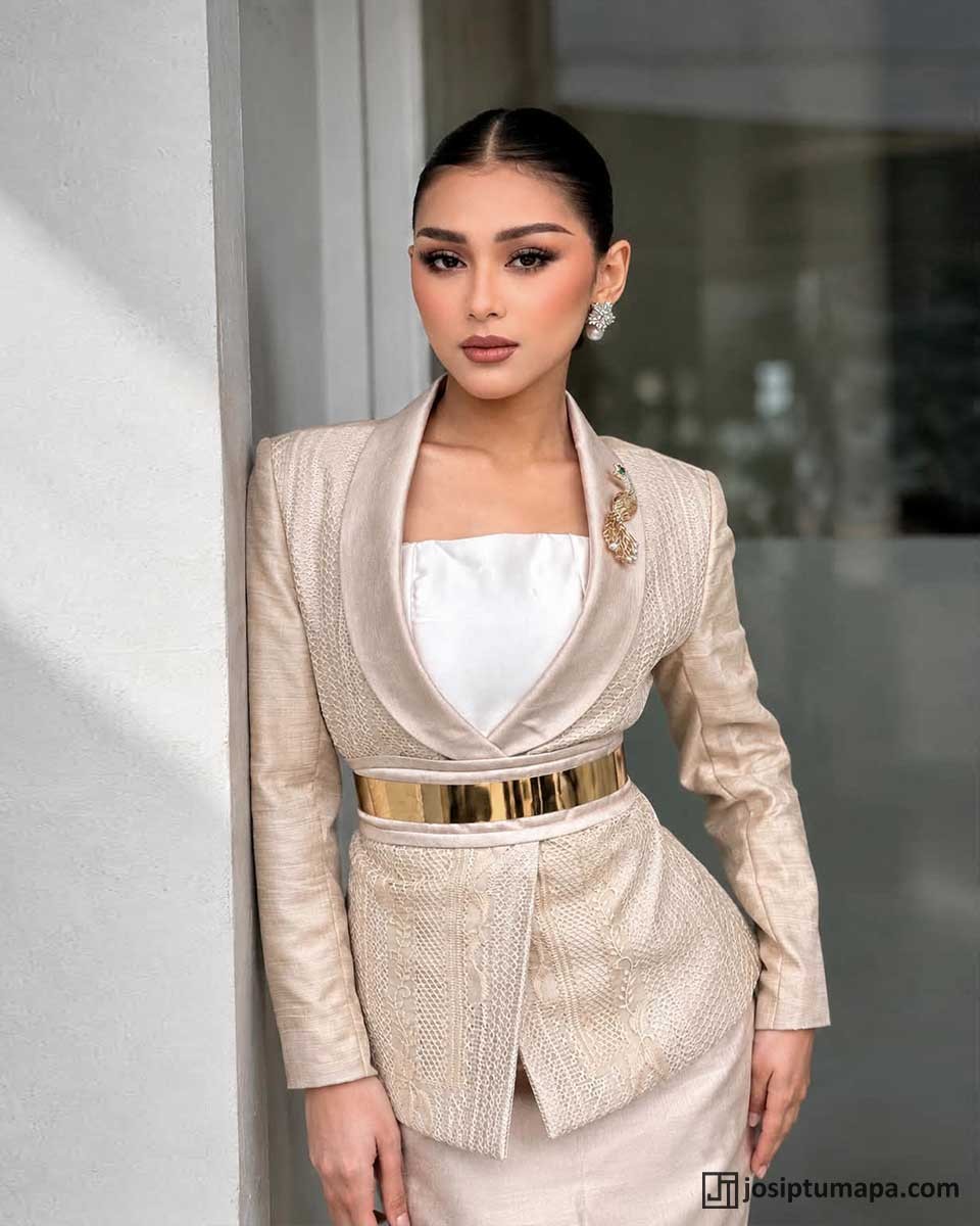 Woman wearing a modern Barong Tagalog with a defined waist, wide metallic belt, and fitted silhouette