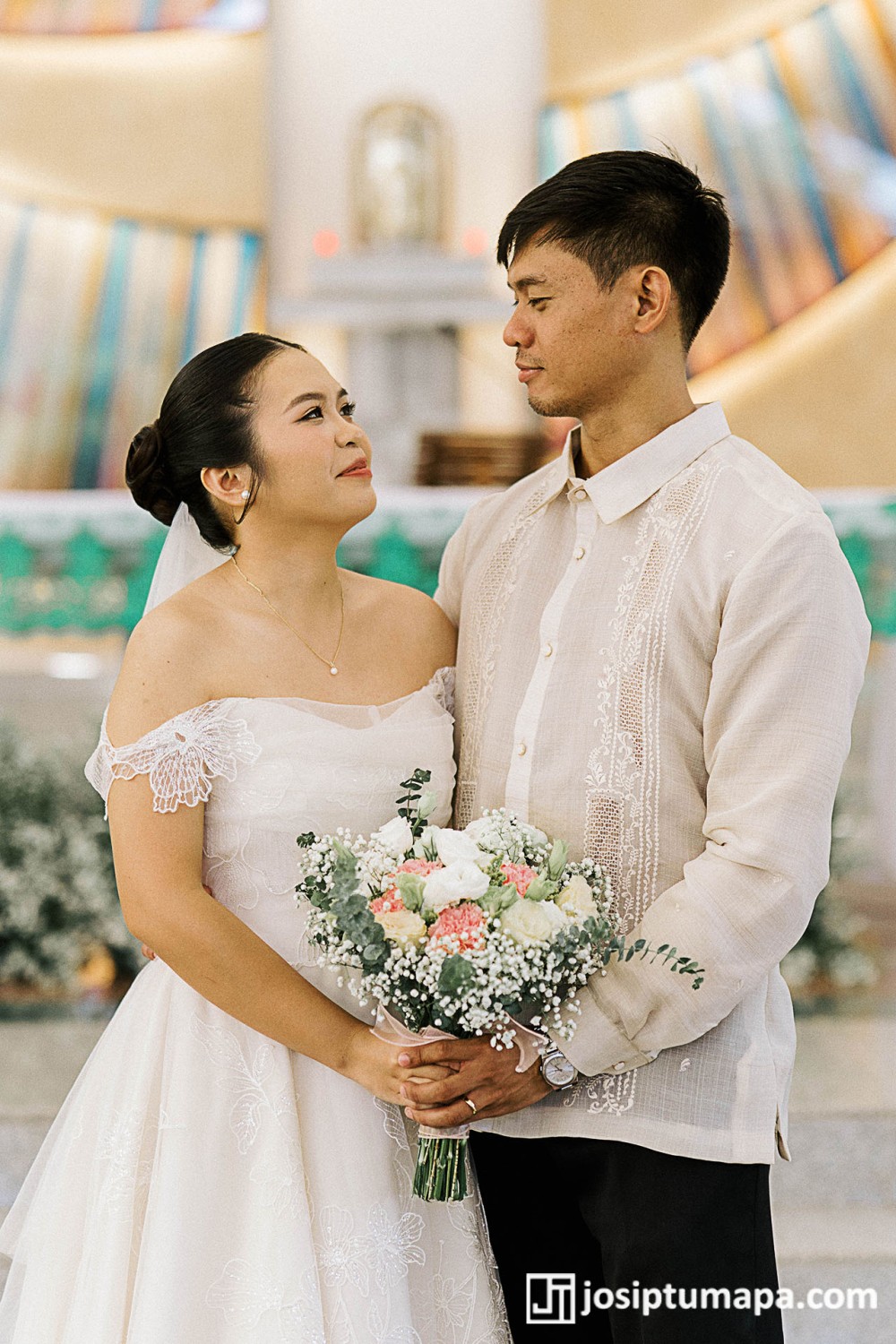 Groom wearing a custom Barong Tagalog made for an outdoor wedding, standing with the bride during the ceremony